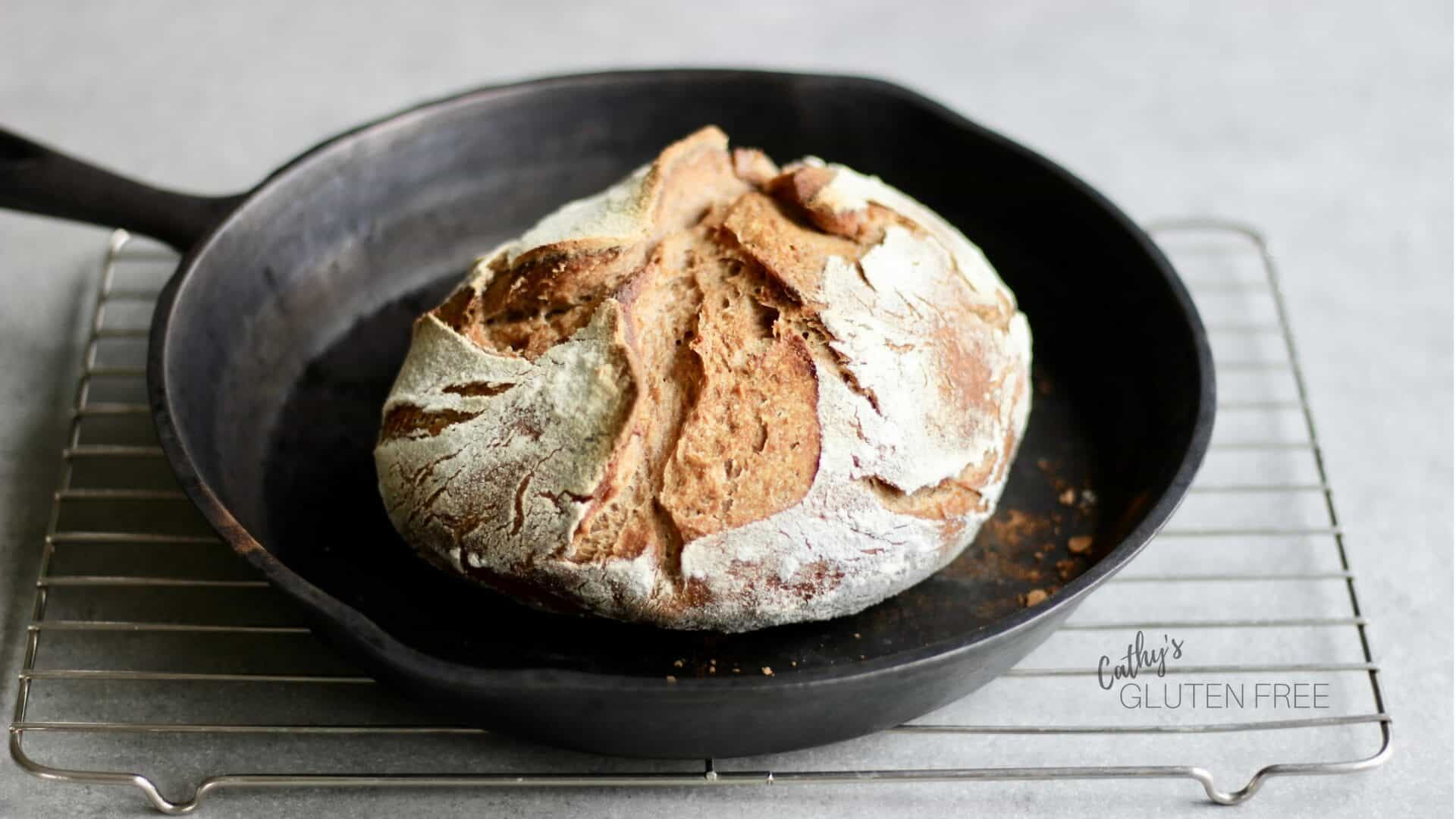 round loaf of bread in a black cast iron skillet