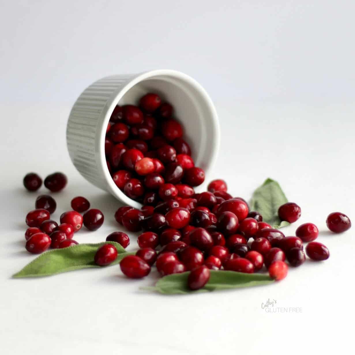 Fresh cranberries spilling from a ramekin - CathysGlutenFree.com