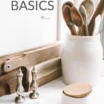 "Gluten Free Basics" text over pale photo of wooden kitchen utensils on white