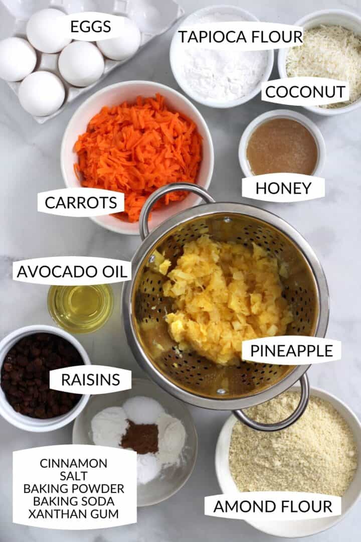 ingredients for carrot cake in individual bowls with labels