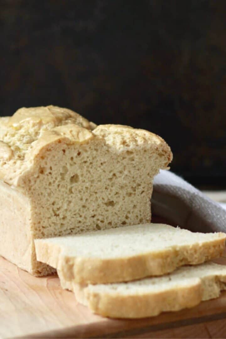 sliced bread on wooden board against a black background