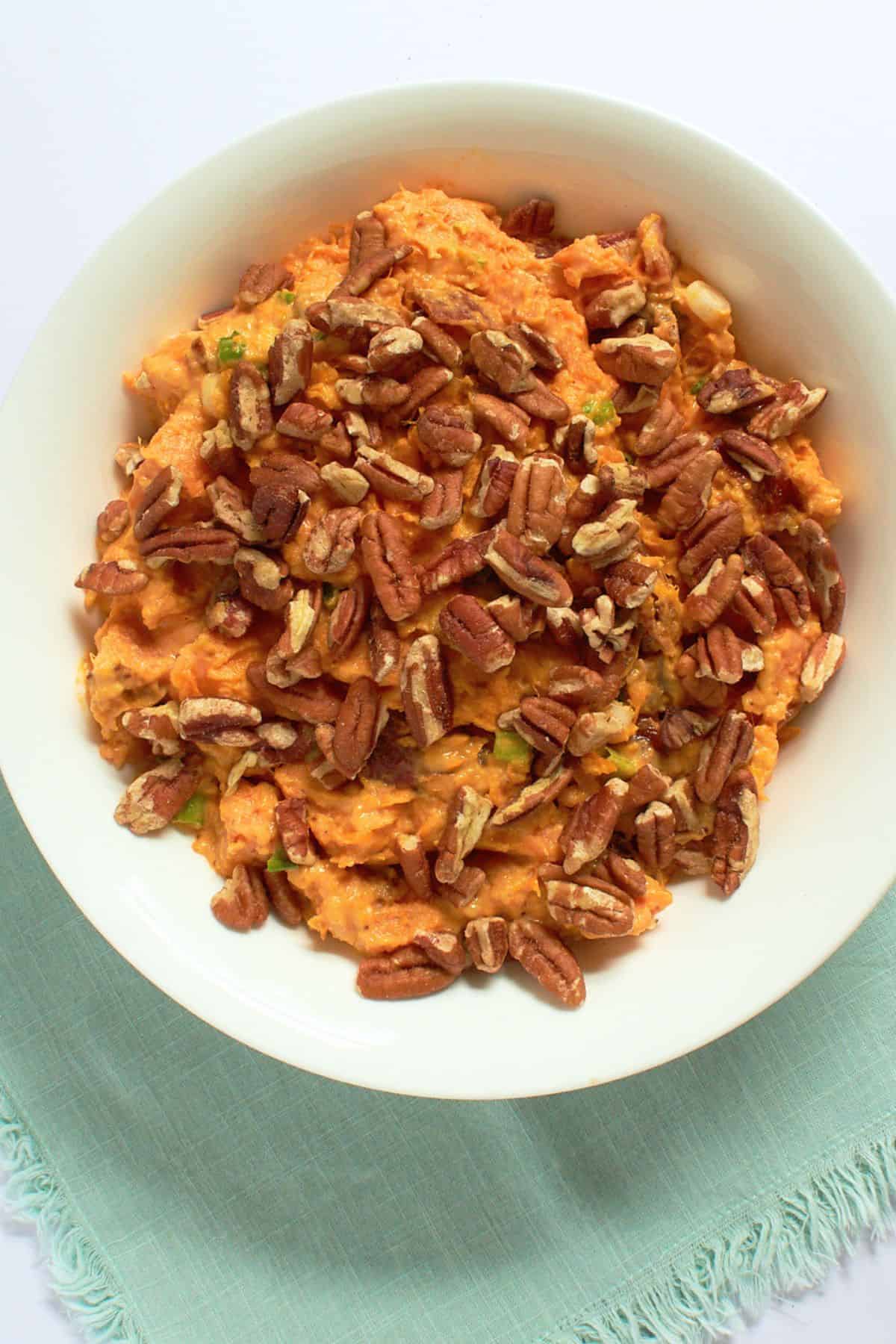 overhead shot of sweet potato salad in white bowl.