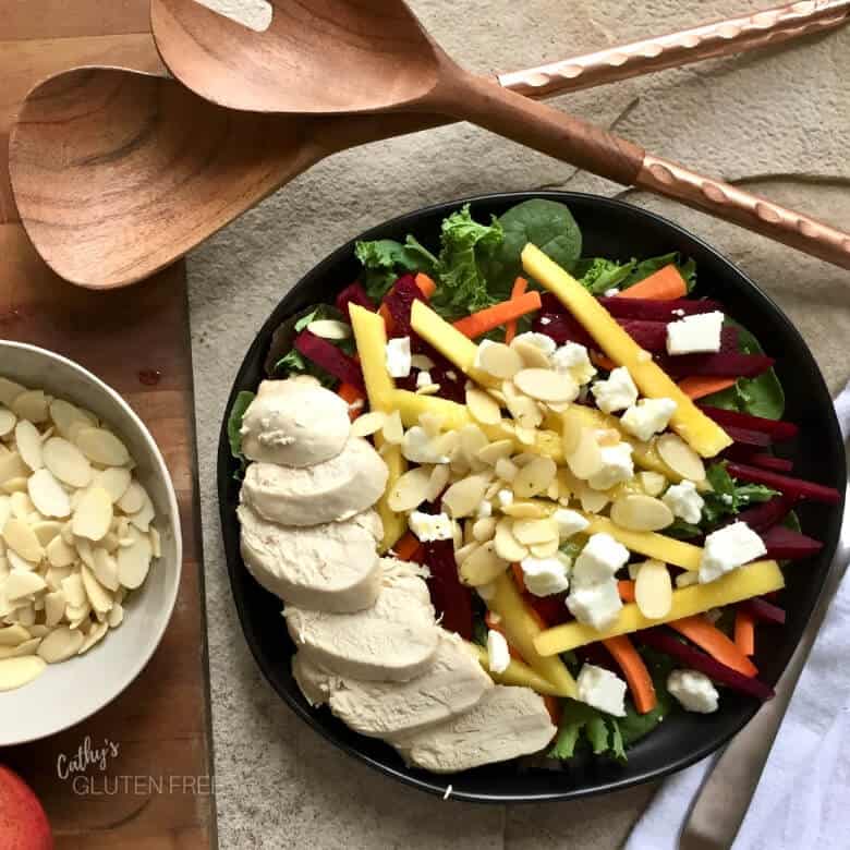 Goat Cheese Sprinkled Over a Mango Avocado Salad with Chicken