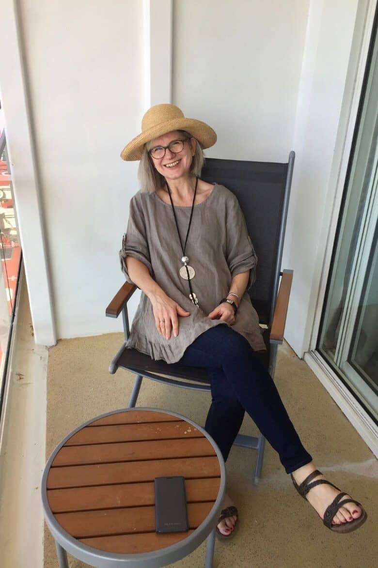 lady in sunhat on balcony