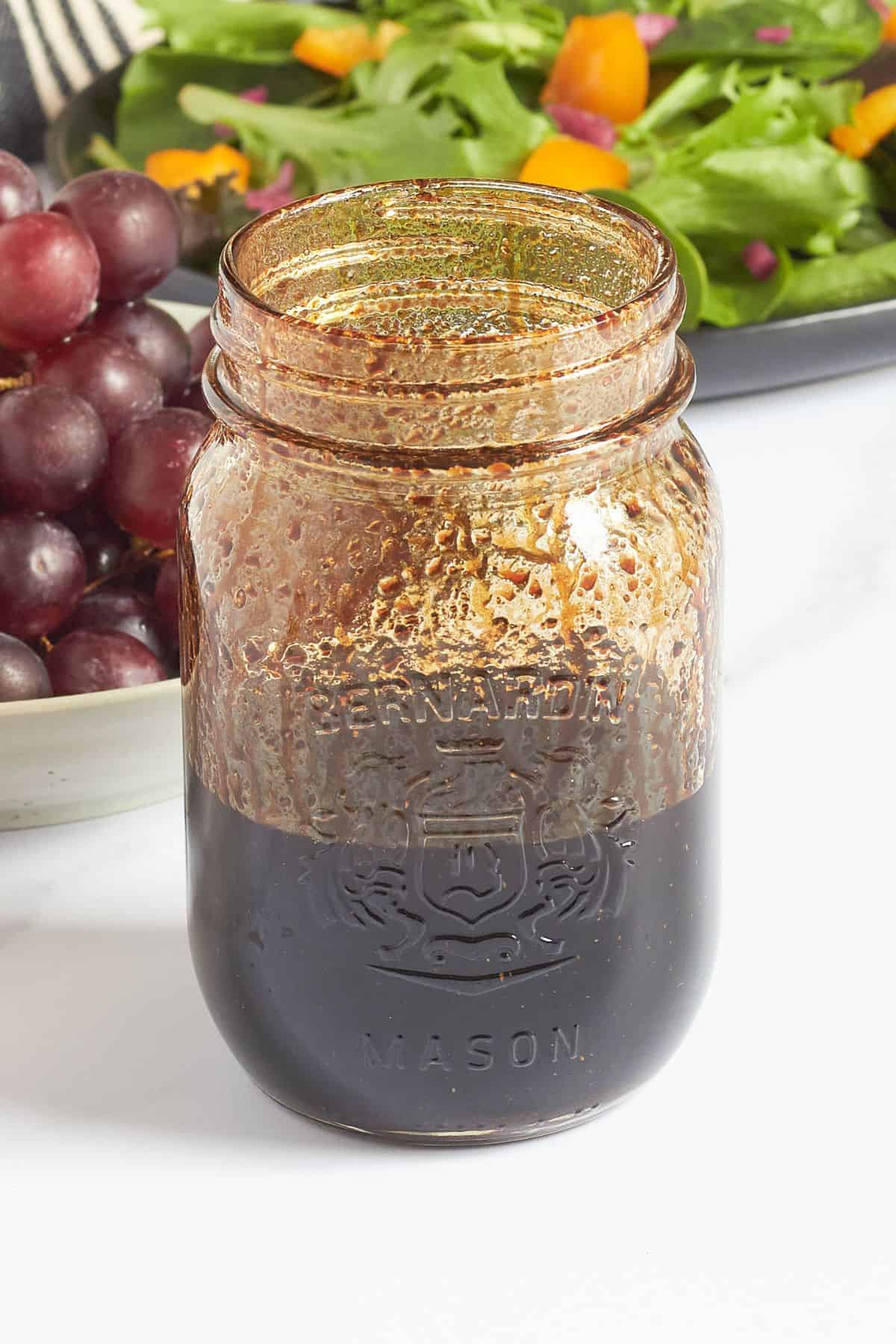mason jar in which balsamic vinaigrettte has been shaken.