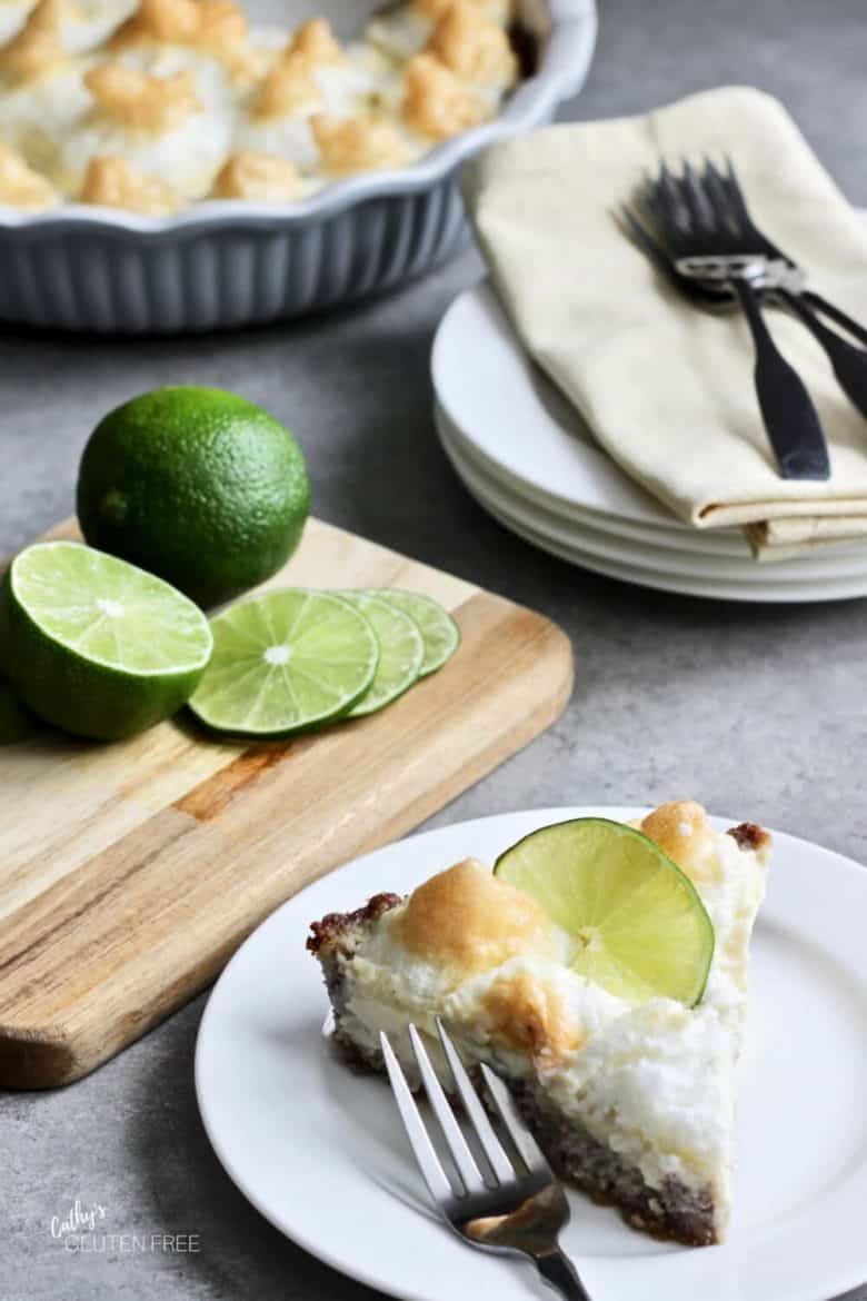 slice of Key lime pie with sliced limes in background