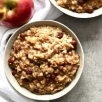 overhead shop of two bowls of oatmeal and apple