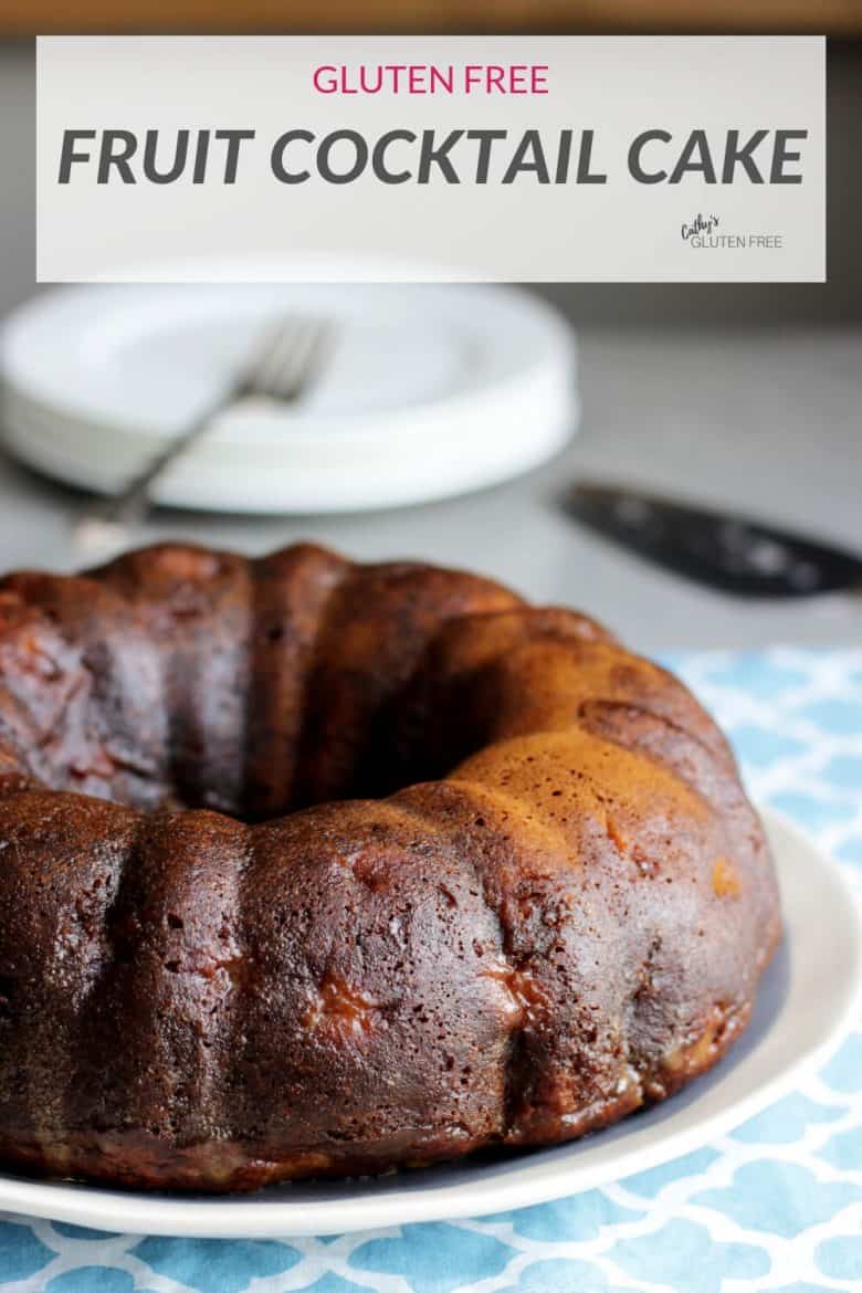 dark brown tubulars-shaped cake with white plates stacked in background