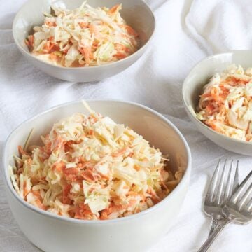 creamy gluten-free coleslaw served in various bowls.