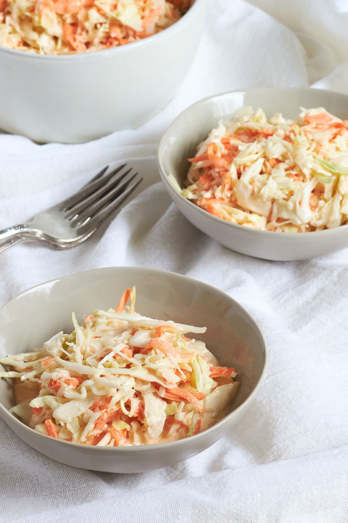 three bowls of gluten-free creamy coleslaw.