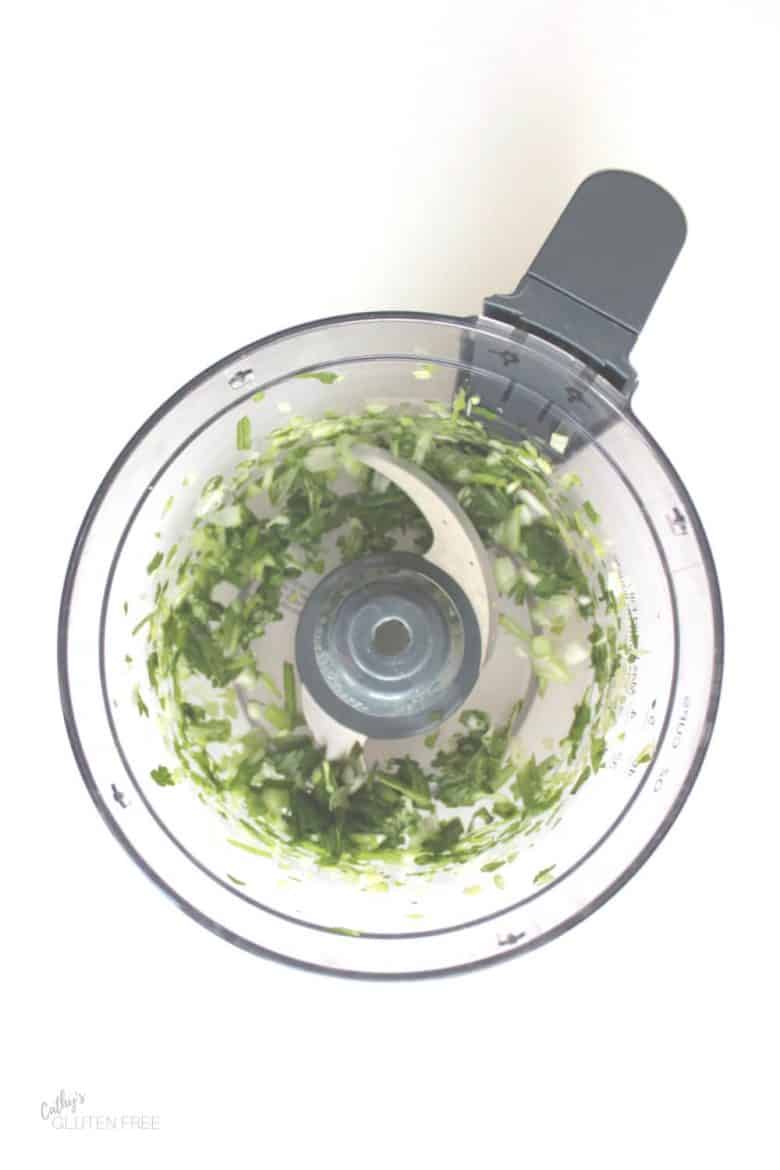 chopped green herbs in food processor