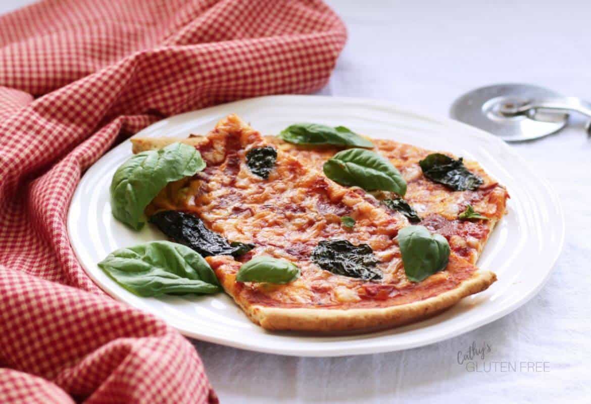 sliced thin crust pizza on a white plate