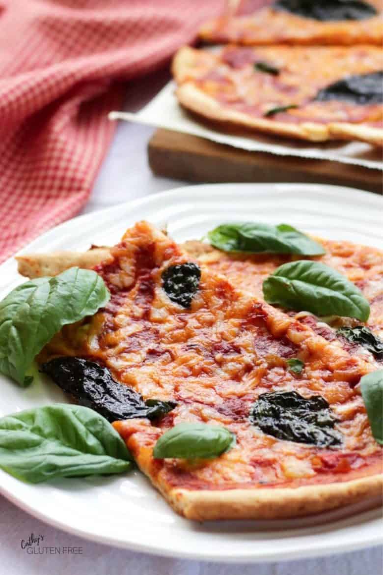 cheese and tomato-topped pizza slices garnished with basil