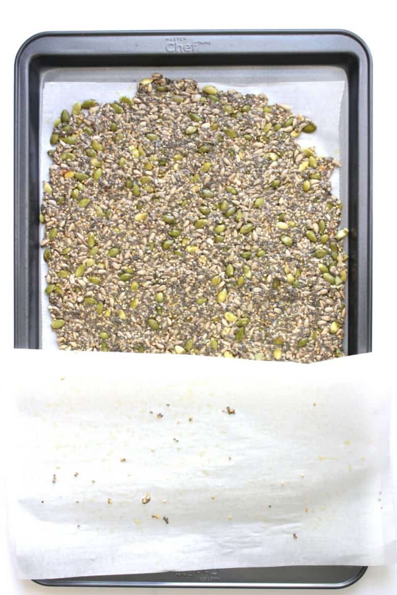 seed batter rolled out onto a parchment-lined baking sheet