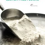 gluten free flour spills from a scoop onto a dark plate