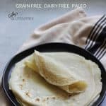 stack of grain free tortillas on black plate, with top one rolled up