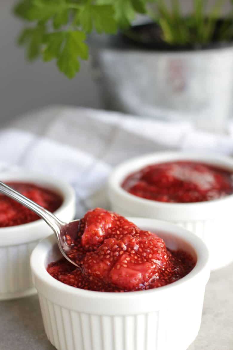 strawberry chia jam spooned into little white pots