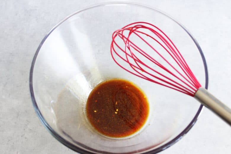 brown vinaigrette in bottom of glass bowl