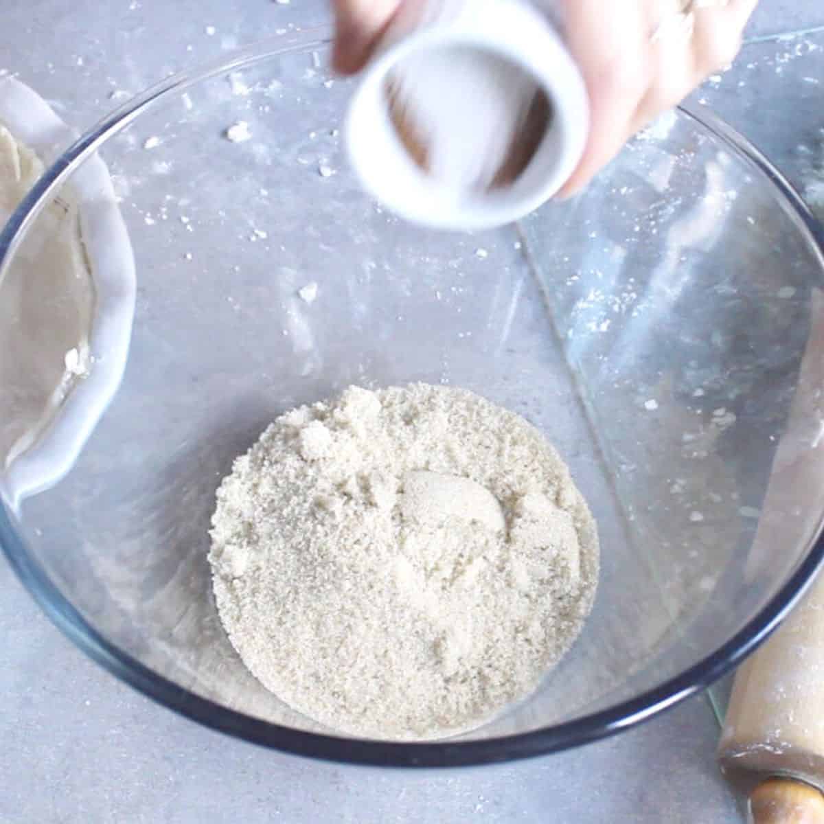 dry ingredients are combined in a glass bowl.