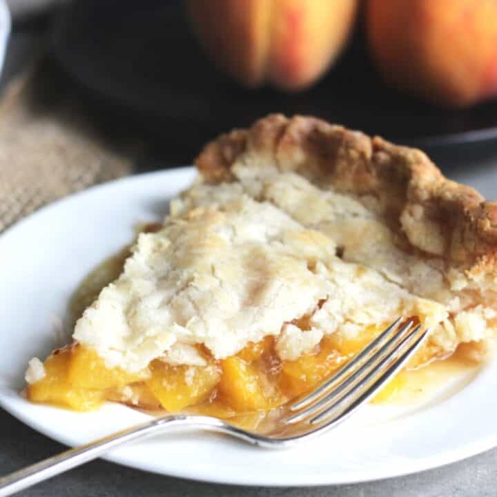 close up shot of a slice of peach pie
