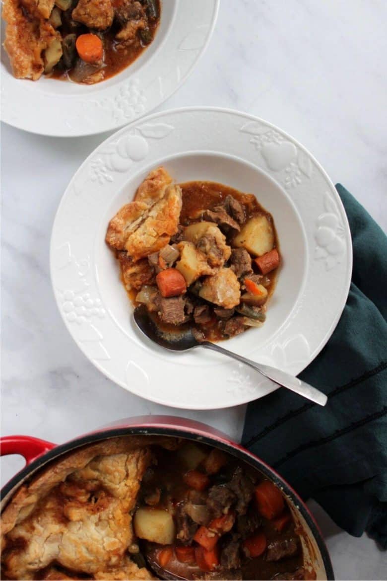 flat lay of beef pot pie served into white bowls