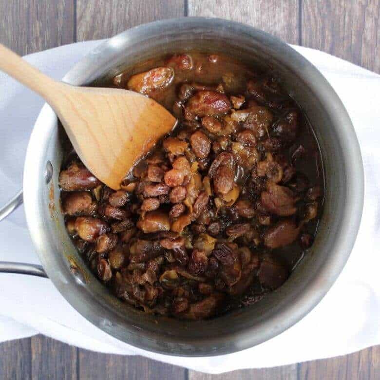 dates and raisins simmering in a pot of water