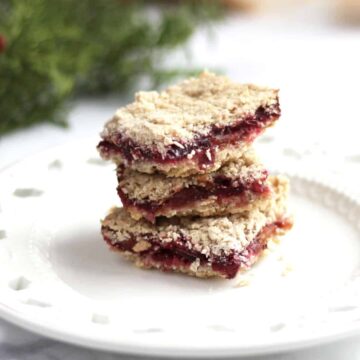 gluten free cranberry bars stacked on white plate