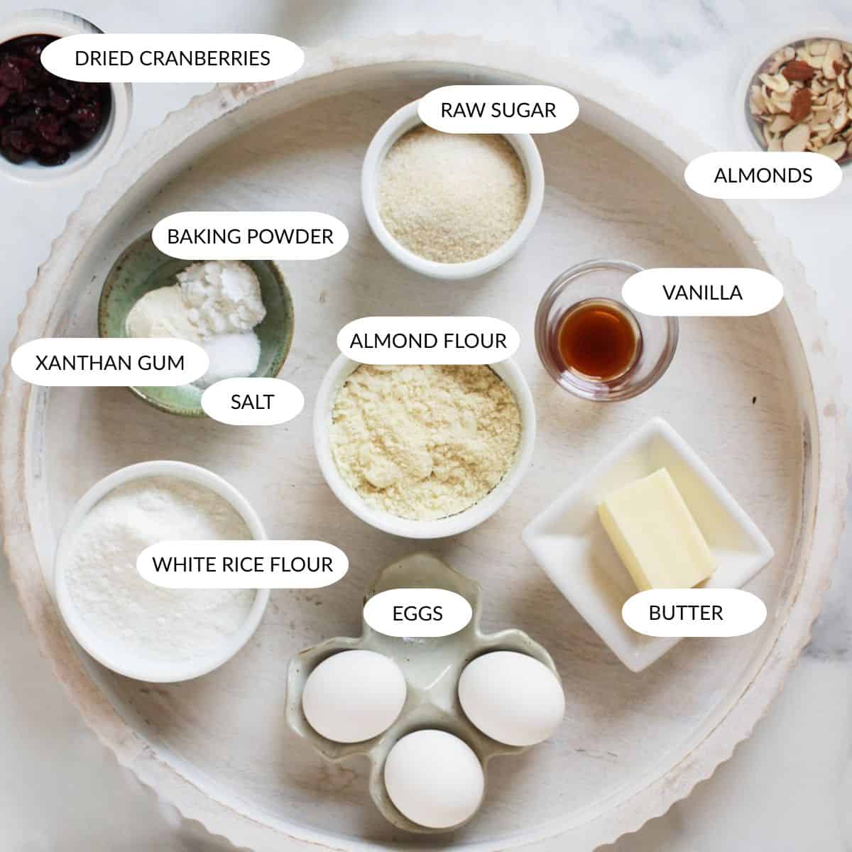 cranberry almond flour biscotti ingredients in small bowls with labels.