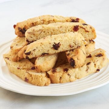 gluten-free cranberry almond biscotti arranged on a white plate.