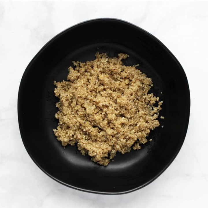 cooked quinoa in black bowl