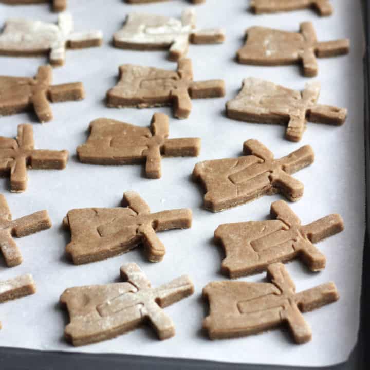 windmill-shaped cookies on baking sheet