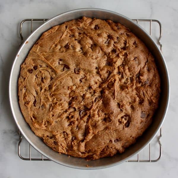 baked chocolate chip cookie cake in round pan