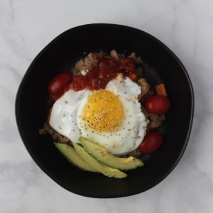 fried egg, salsa, and avocado on quinoa bowl