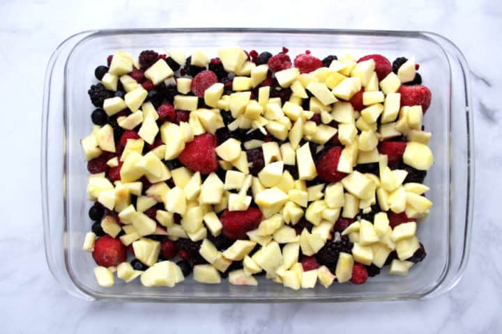 berries and chopped, peeled apples spread over bottom of pyrex baking pan