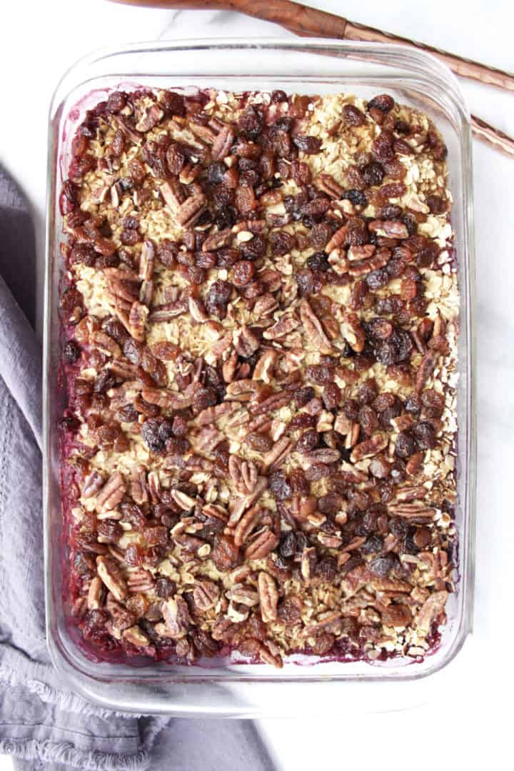 flat lay of casserole with oatmeal, raisins, and pecans in rectangular pyrex pan