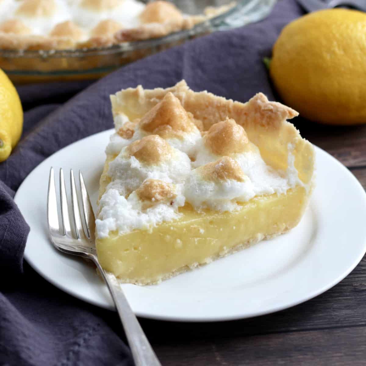 slice of lemon meringue pie on white plate