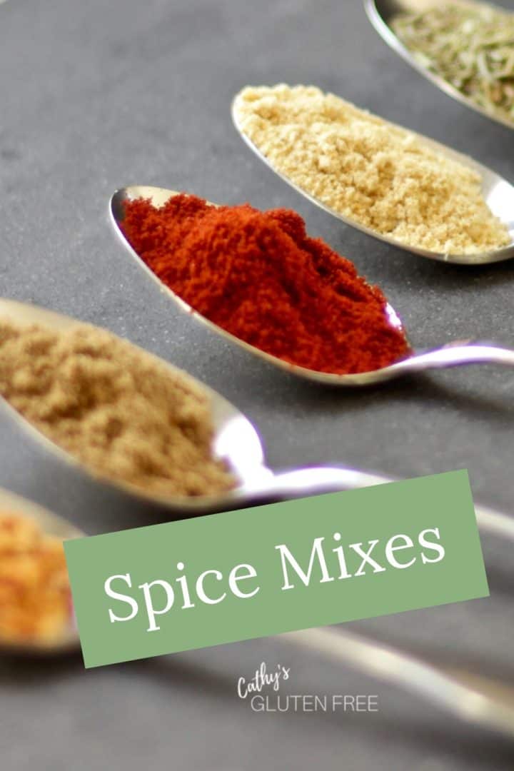 spoons of colourful spices lined up in a row with text "Spice Mixes"