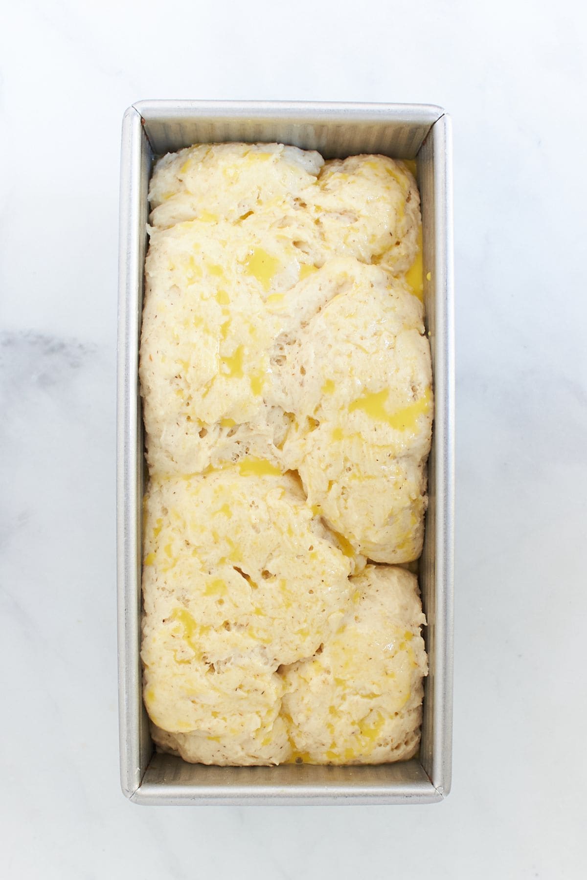 risen gluten-free bread batter brushed with egg wash.