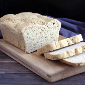 sliced gluten free bread on wooden board