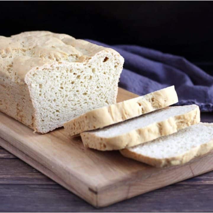 sliced gluten free brioche on wooden cutting board