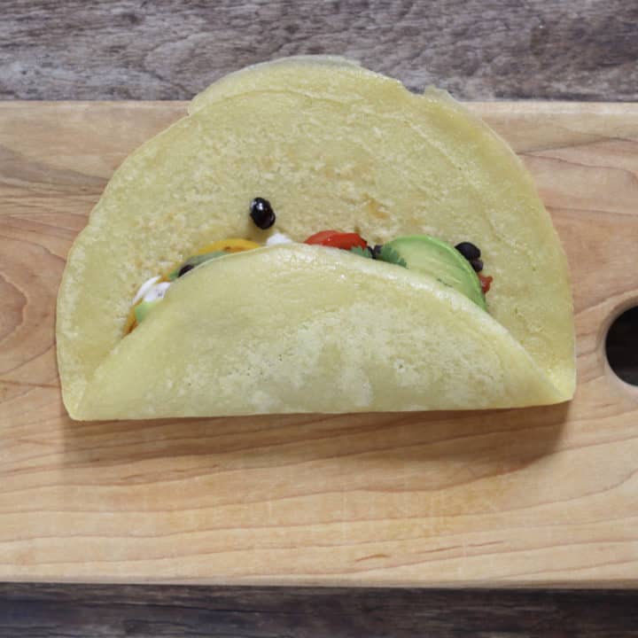 one side of tortilla folded over burrito filling