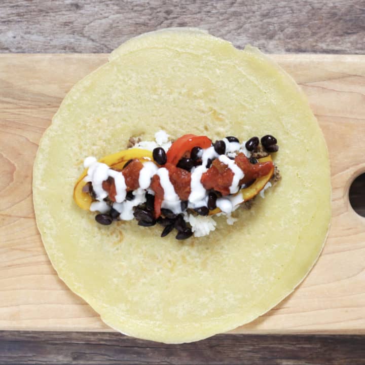 yogurt drizzled over burrito filling