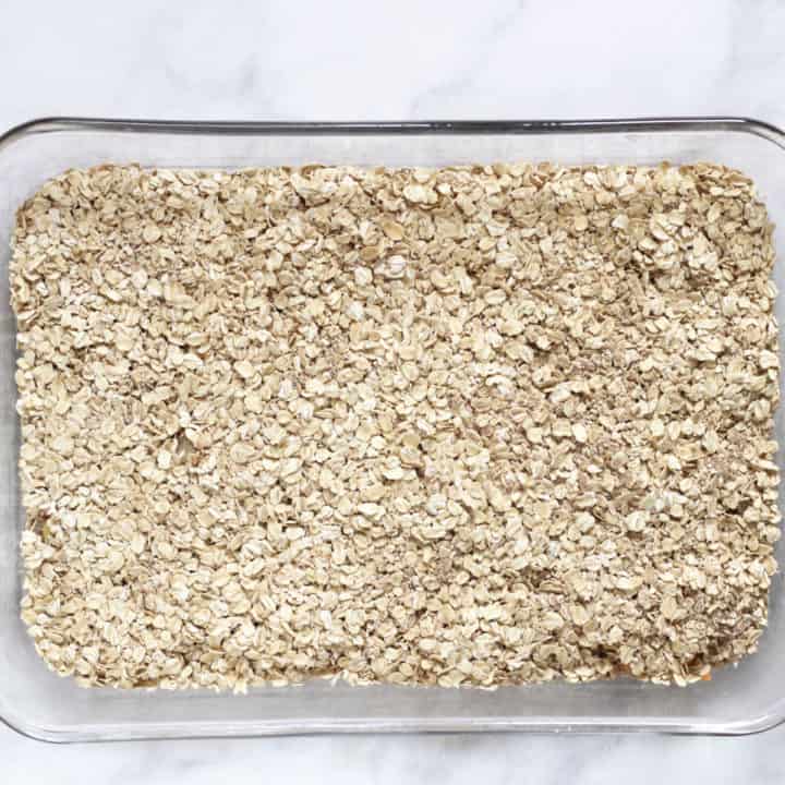 layer of oats in glass baking pan