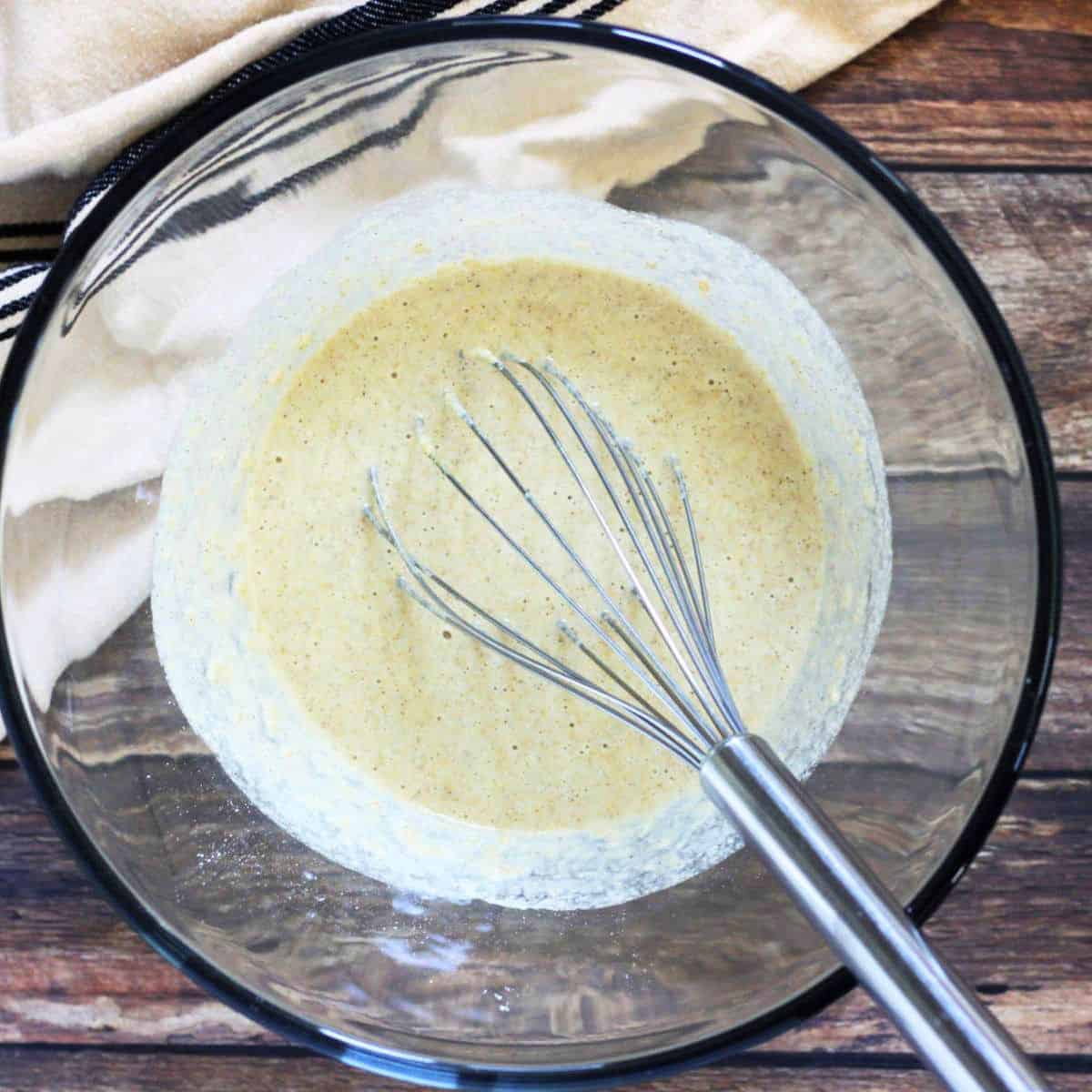the mixture becomes runny as more liquid is whisked in.