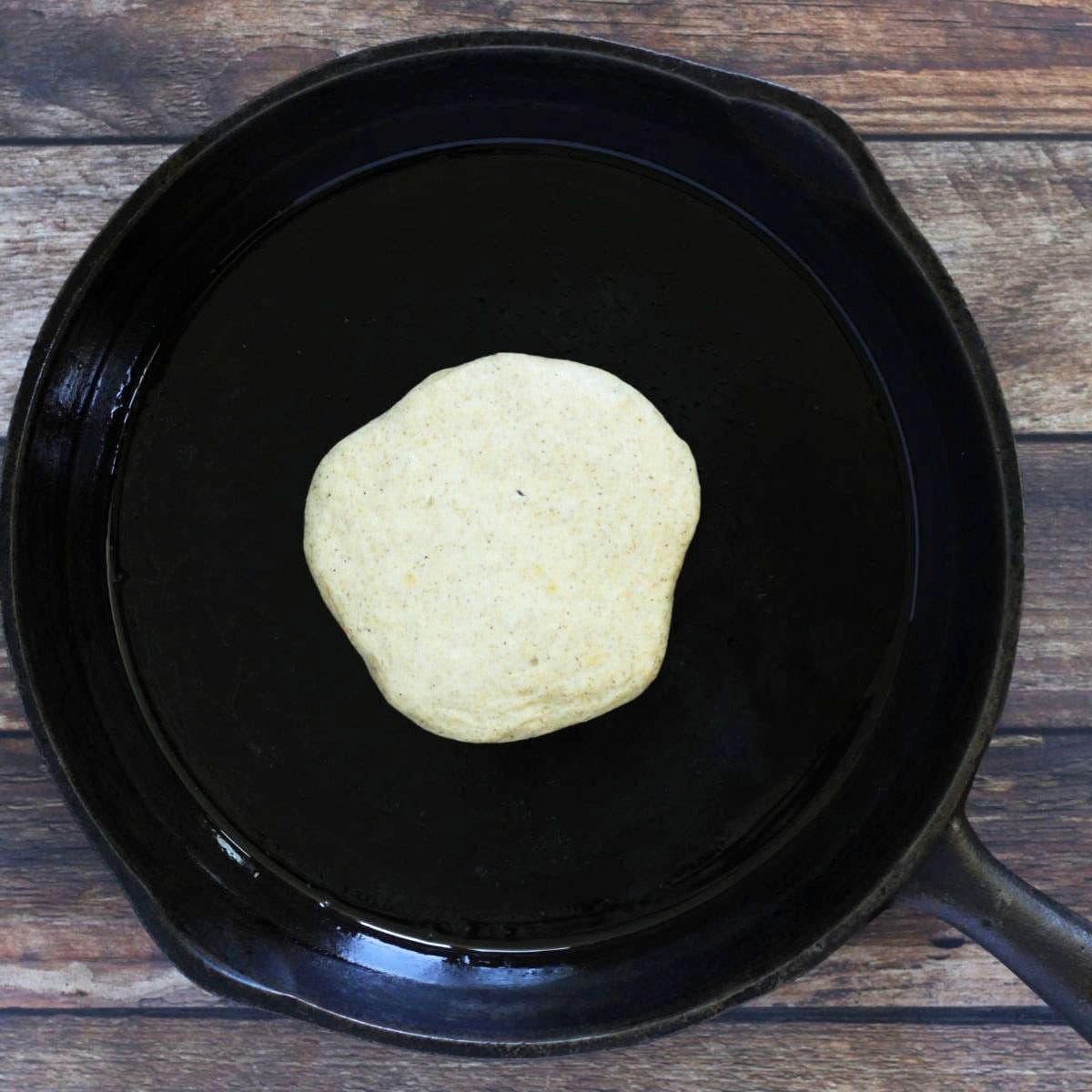pancake cooking in a cast iron pan.