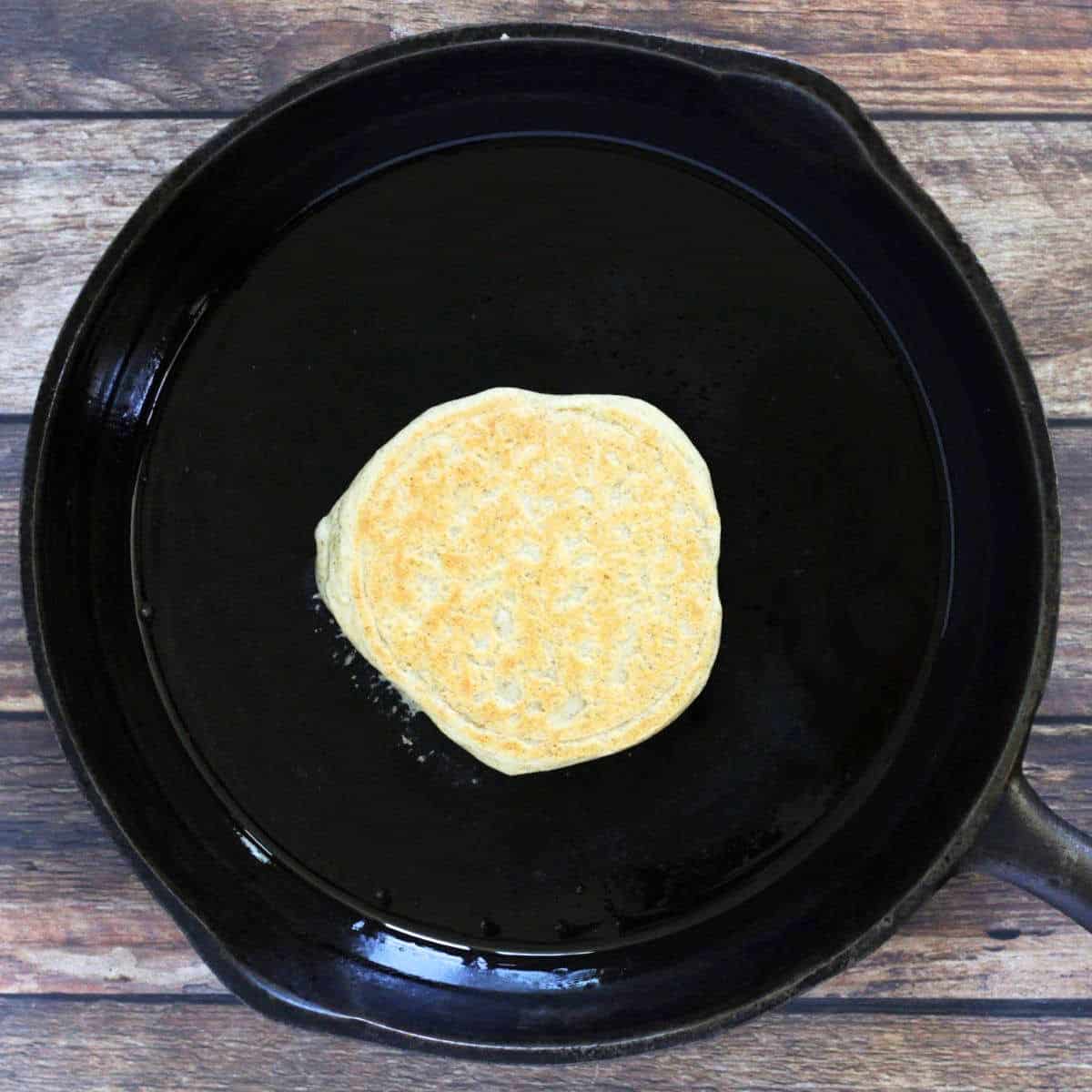 golden brown top on pancake that has been flipped over.