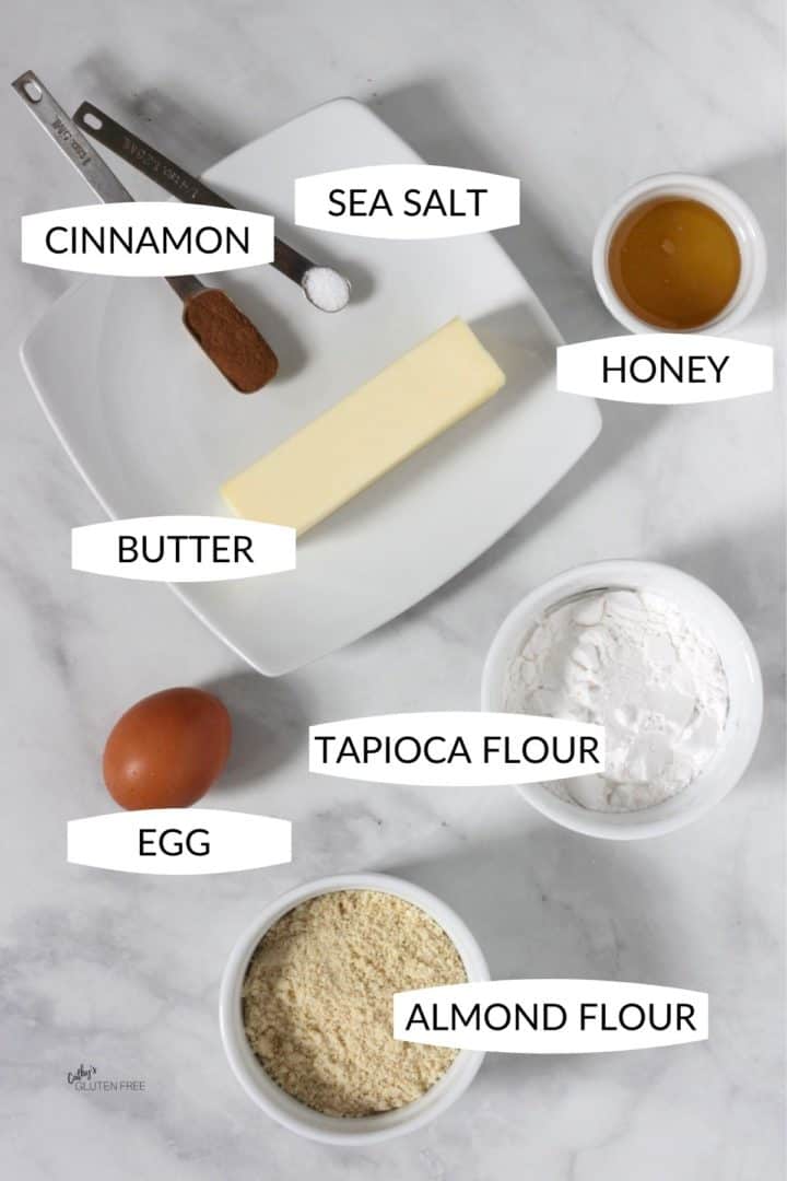 small bowls with tapioca flour, almond flour, egg, butter, honey, cinnamon, and salt
