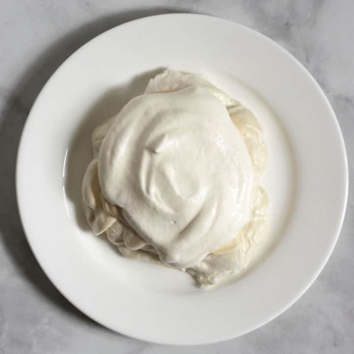 whipped cream mounded on top of baked meringue