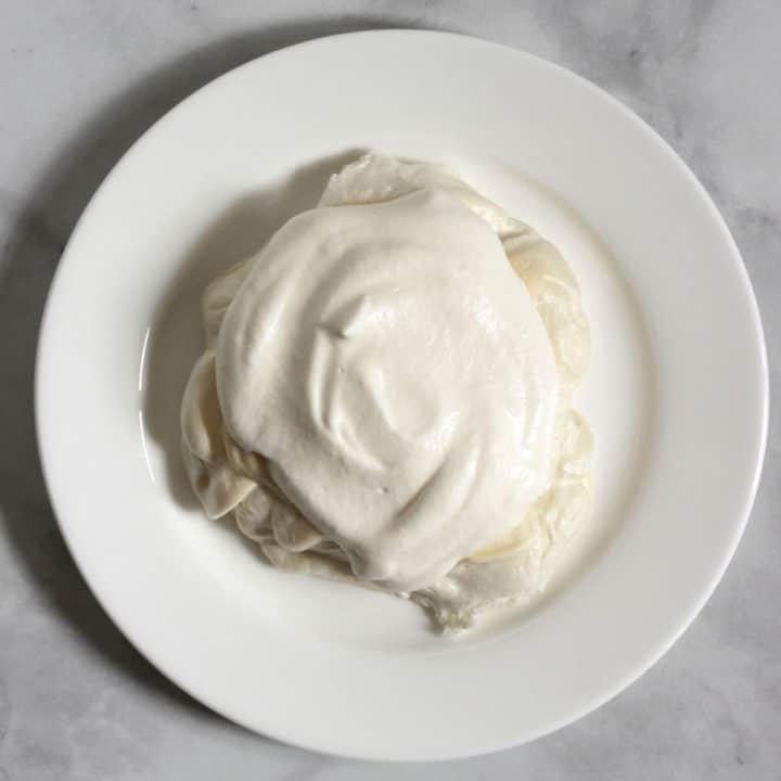 whipped cream mounded on top of baked meringue