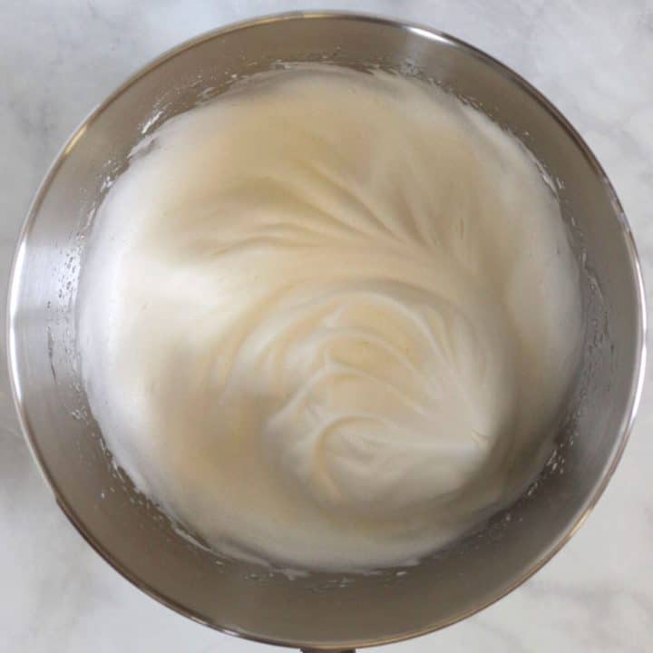 glossy, beaten egg whites in bowl of stand mixer